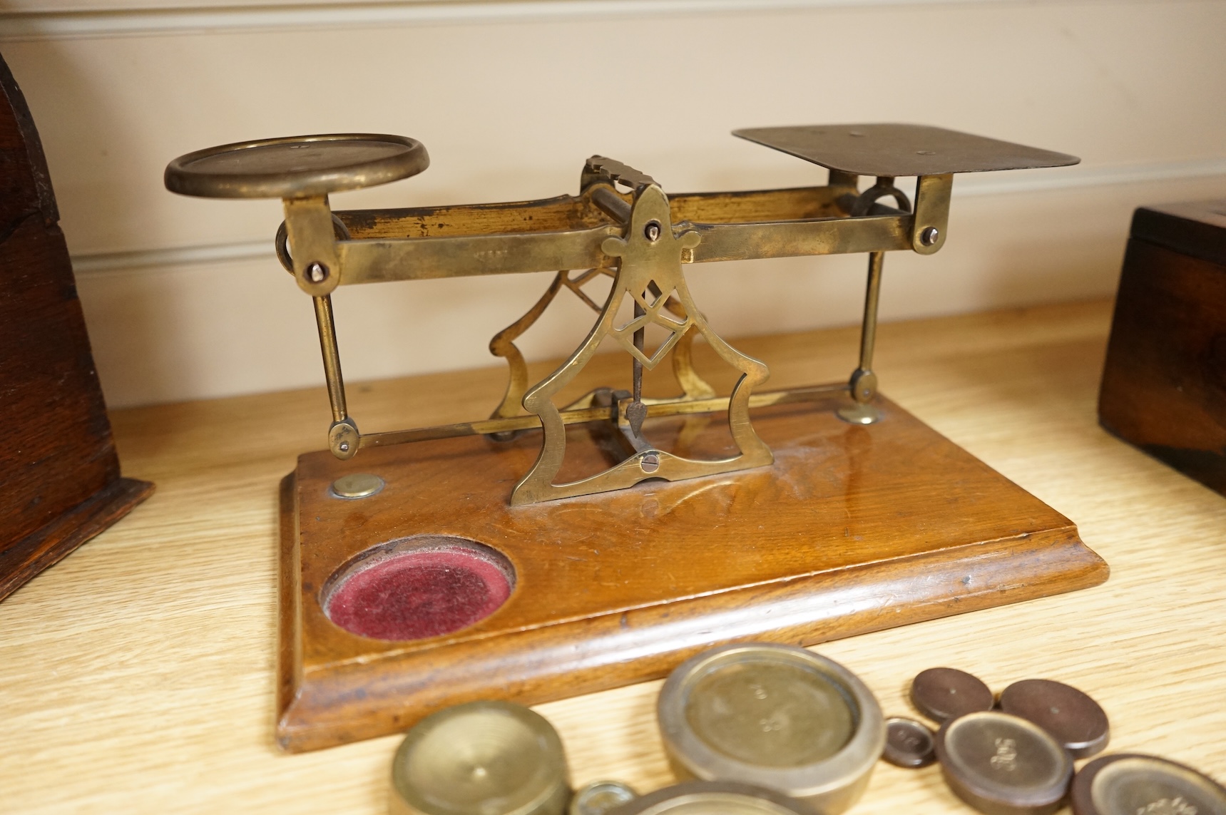A tooled leather writing slope, a letter rack and postage scales, largest 37cm wide